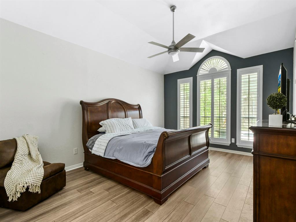 4025 Azure Lane Addison, TX 75001 - Photo 17 of 40 a bedroom with a bed couch and a large window