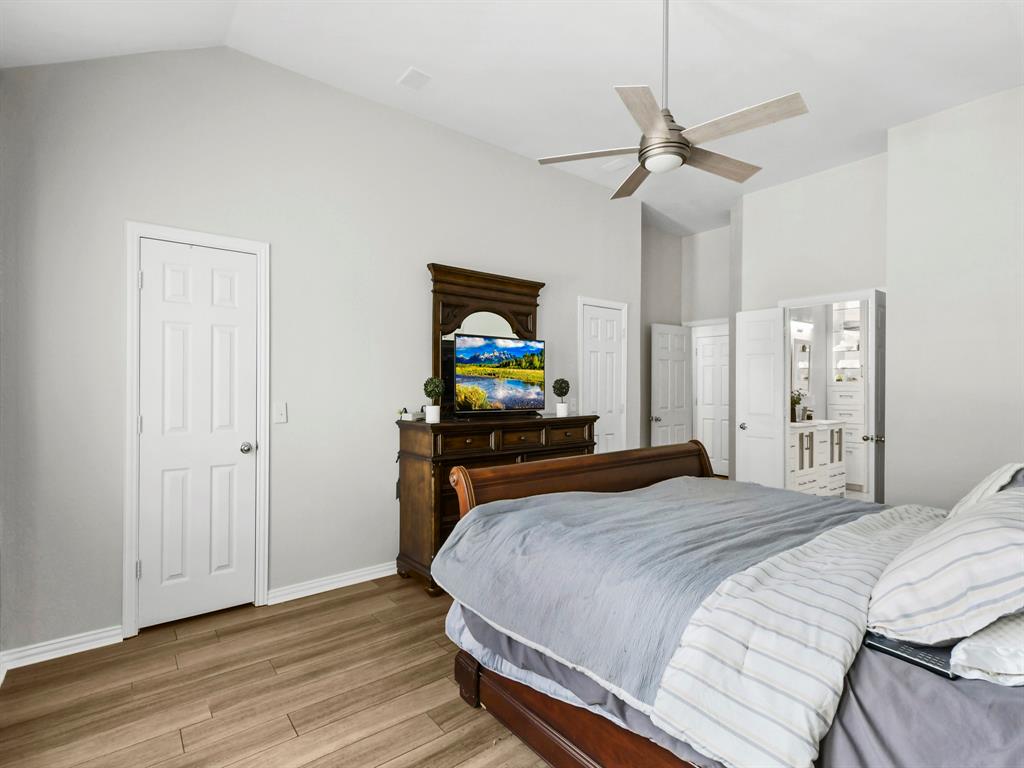 4025 Azure Lane Addison, TX 75001 - Photo 18 of 40 a bedroom with a bed and wooden floor