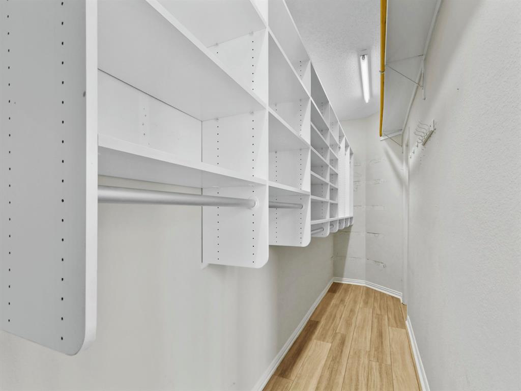 4025 Azure Lane Addison, TX 75001 - Photo 22 of 40 a view of walk in closet with empty racks