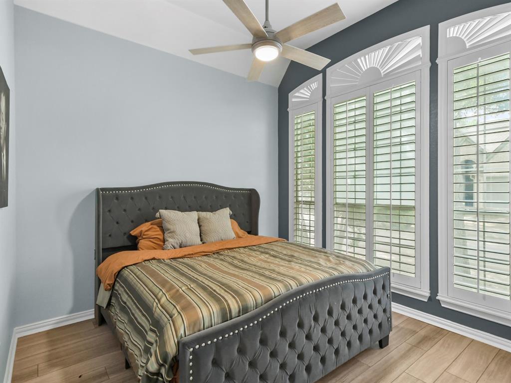 4025 Azure Lane Addison, TX 75001 - Photo 23 of 40 a bedroom with a bed and wooden floor