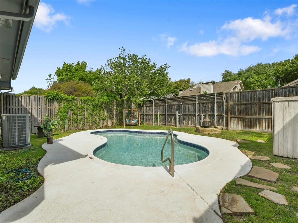 4025 Azure Lane Addison, TX 75001 - Photo 28 of 40 a view of a swimming pool with a yard and sitting area