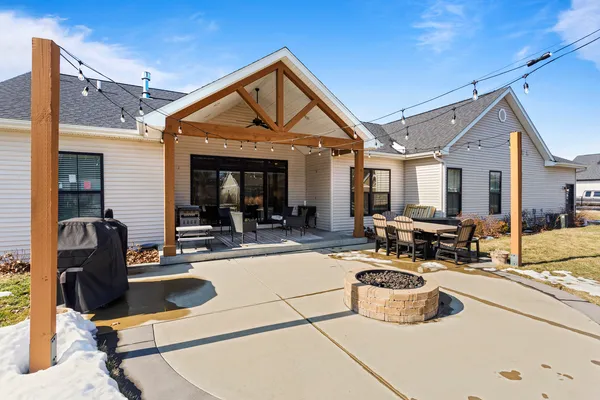 a view of a patio with couches chairs and a stove