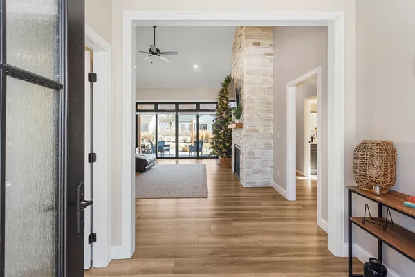 a view of a hallway with wooden floor and staircase