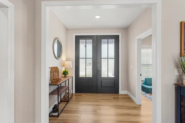 a view of entryway with window and wooden floor