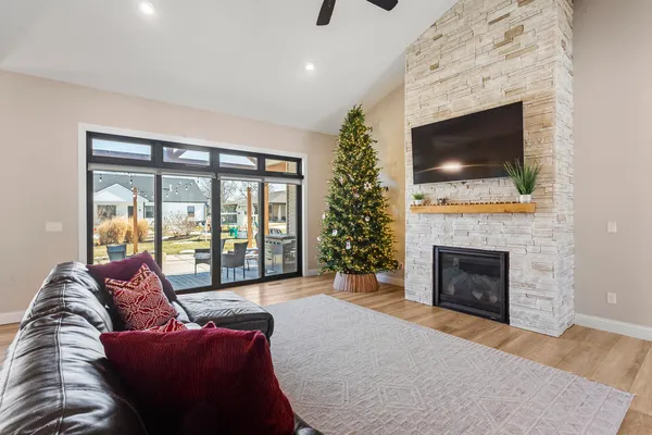 a living room with furniture a flat screen tv and a fireplace