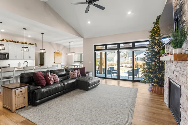 a living room with furniture large window and a fireplace