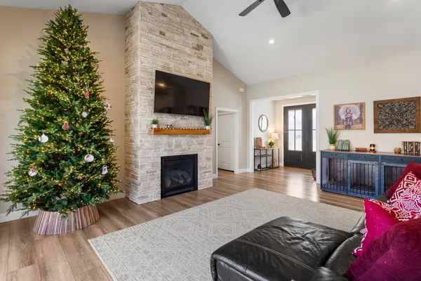 a living room with furniture a flat screen tv and a fireplace
