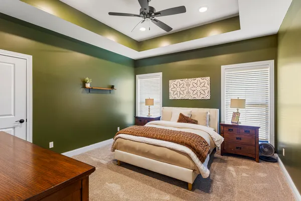 a bedroom with a bed and a chandelier