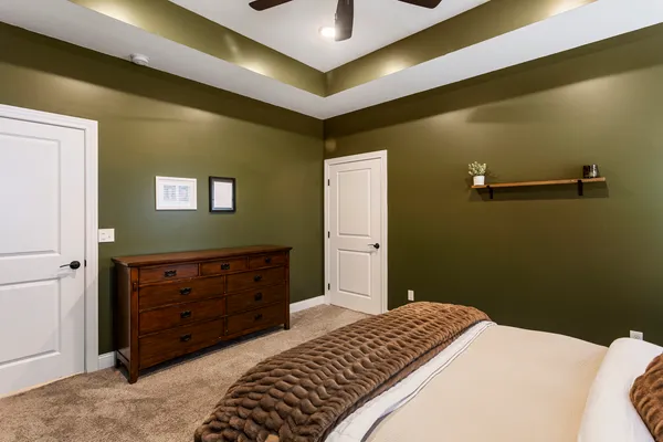a bedroom with a bed and a dresser