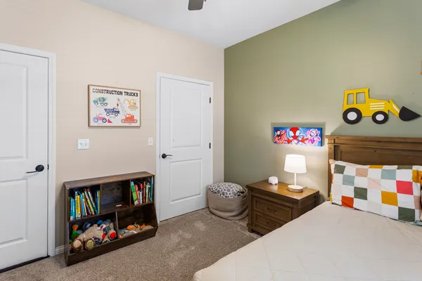 a bedroom with two beds and a closet