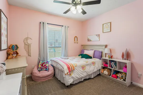 a bedroom with a bed and a bookshelf