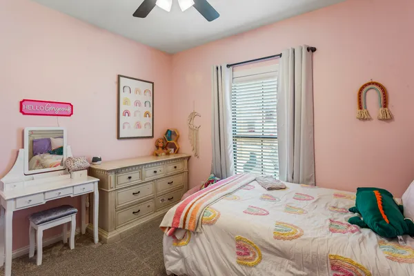 a bedroom with a bed and a dresser