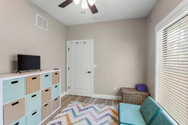 a bedroom with a bed and a television