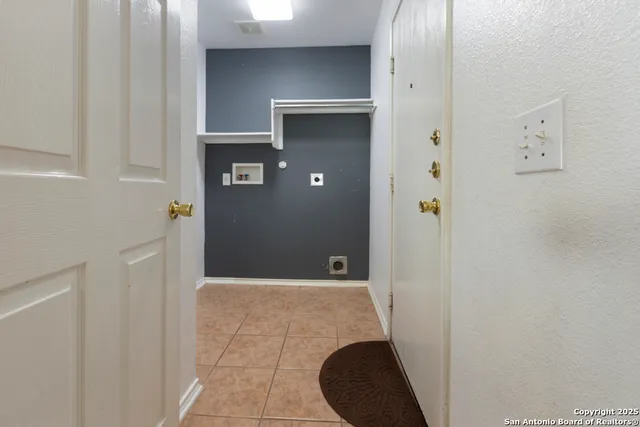a view of a hallway with wooden shelves