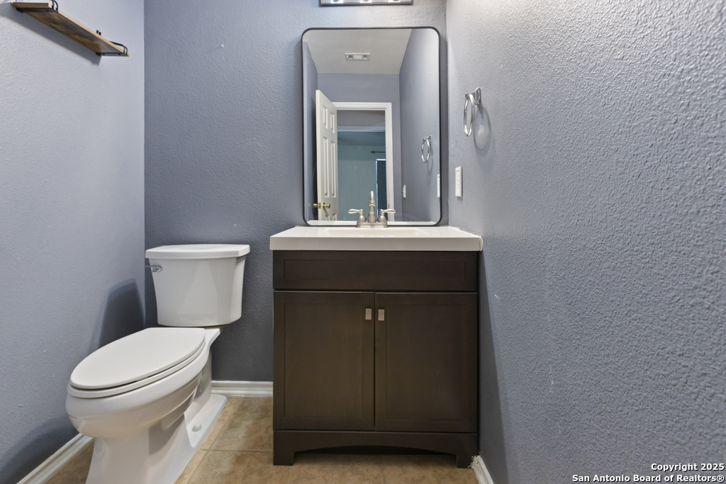 5109 Brookline Schertz, TX 78108 - Photo 14 of 35 a bathroom with a toilet sink and mirror