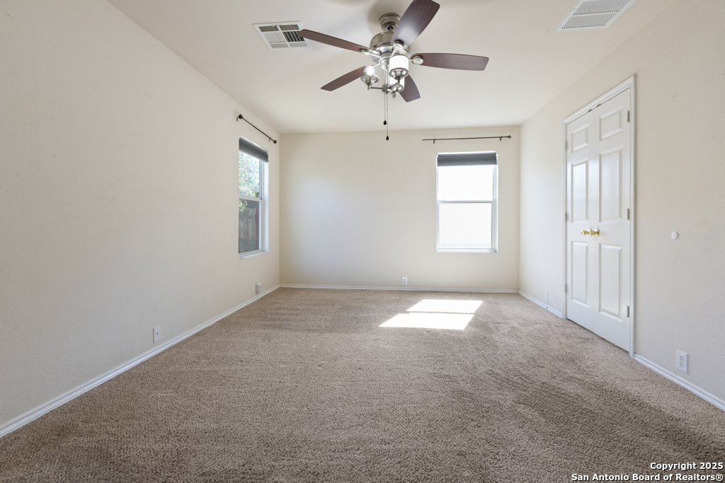 5109 Brookline Schertz, TX 78108 - Photo 16 of 35 en empty room with windows and ceiling fan