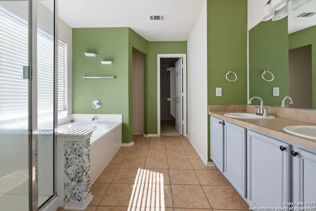 a bathroom with a sink a mirror and a bathtub