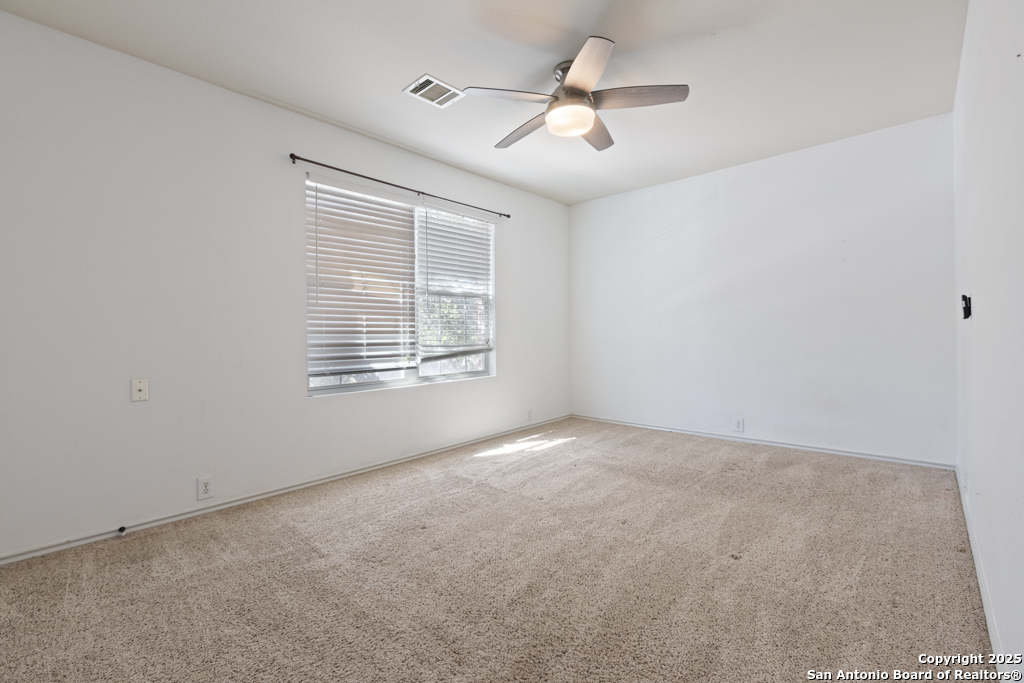 5109 Brookline Schertz, TX 78108 - Photo 23 of 35 an empty room with windows and ceiling fan