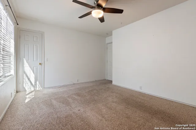 a view of an empty room and a window