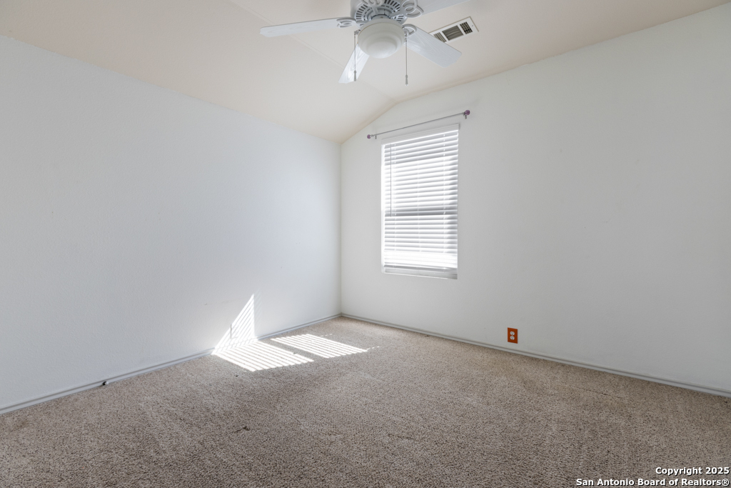 5109 Brookline Schertz, TX 78108 - Photo 30 of 35 an empty room with a chandelier fan and windows