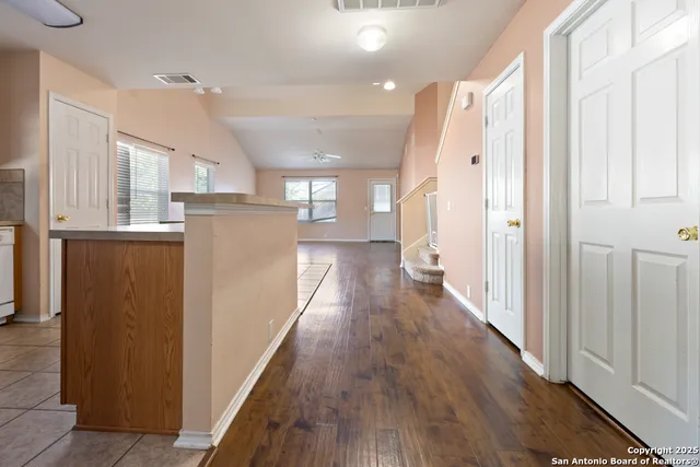 a view of a kitchen with wooden floor and electronic appliances