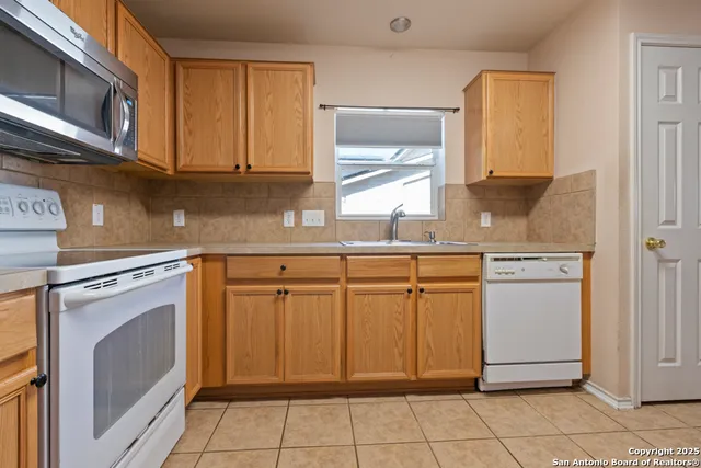 a kitchen with stainless steel appliances granite countertop a refrigerator and cabinets