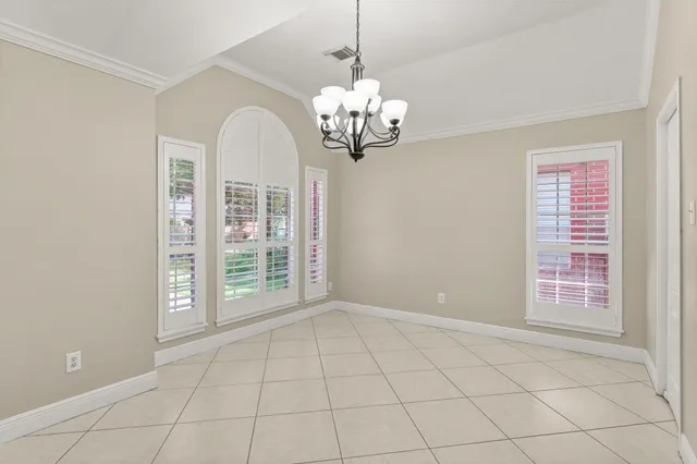 a view of an empty room with a fireplace and a window