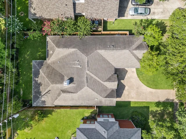 an aerial view of a house with a garden and yard