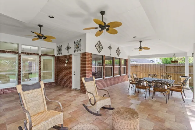 a view of a house with backyard porch and sitting area