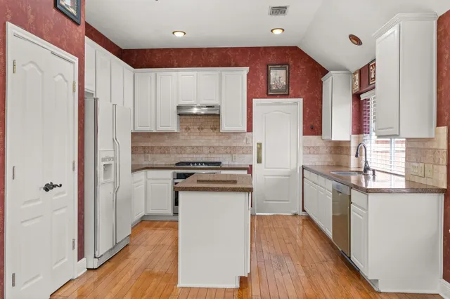 a kitchen with a stove and a refrigerator