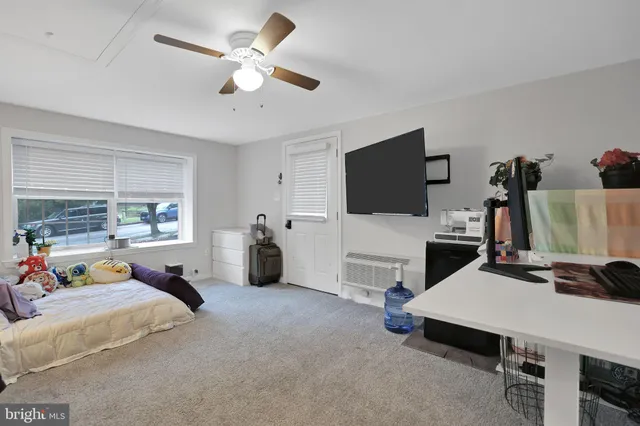 a bed room with furniture and a flat screen tv