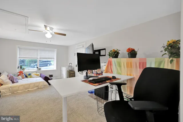 a bedroom with a bed window and a flat screen tv