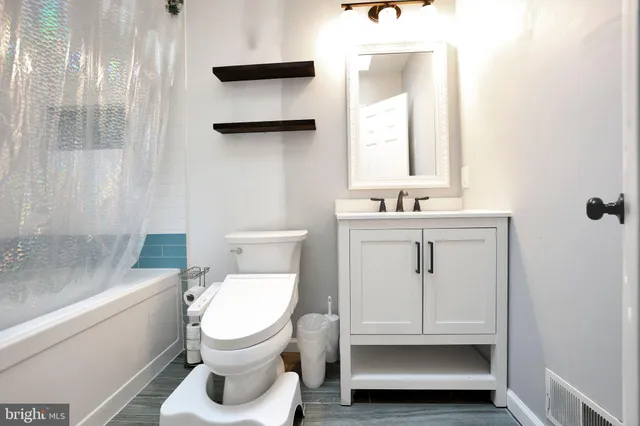 a bathroom with a toilet a sink and a window