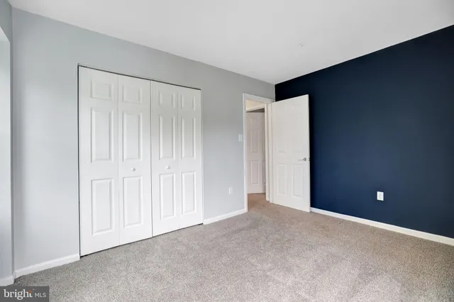 an empty room with closet area