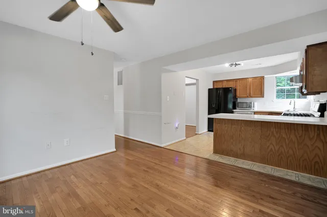 a view of kitchen with granite countertop cabinets and wooden floor