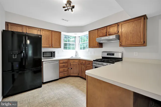 a kitchen with a refrigerator and a sink