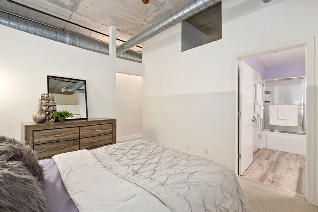 a bedroom with a bed and a table