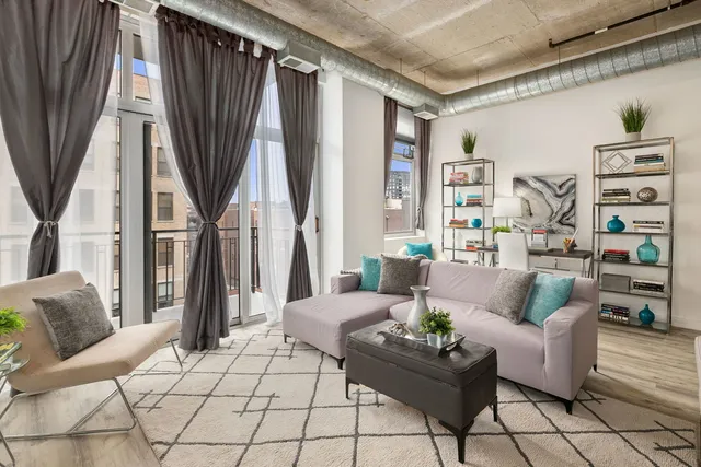 a living room with furniture and a book shelf