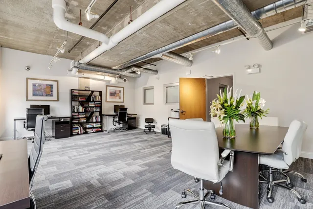 a living room with furniture and large windows