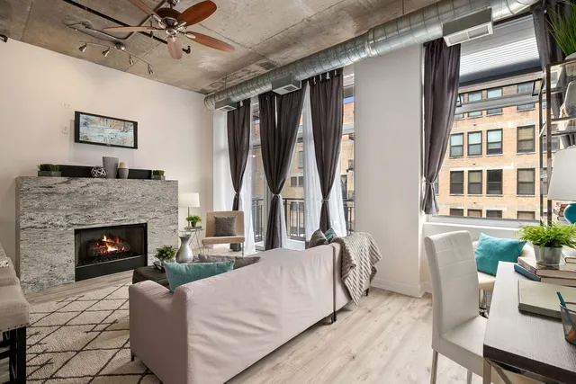 a living room with furniture and a fireplace