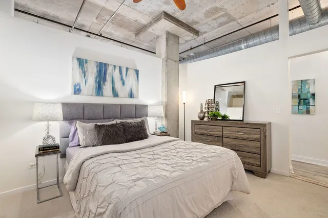 a bedroom with a bed and a dresser