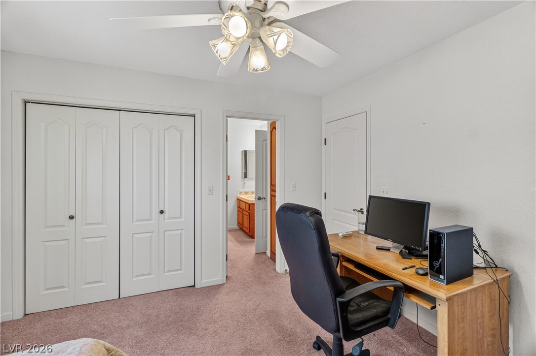 2055 Cholla Way Laughlin, NV 89029 - Photo 27 of 87 A versatile room featuring a functional desk, closet space, and easy access to an adjacent bathroom.