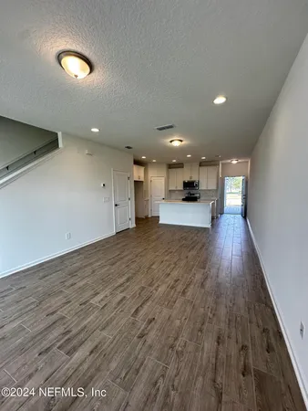 a view of a kitchen with a sink and wooden floor