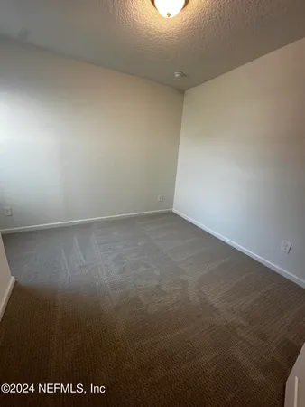 an empty room with a mirror