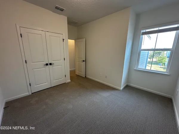 an empty room with an entrance to other room