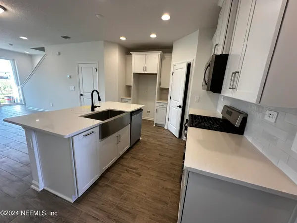 a kitchen with refrigerator and a counter top