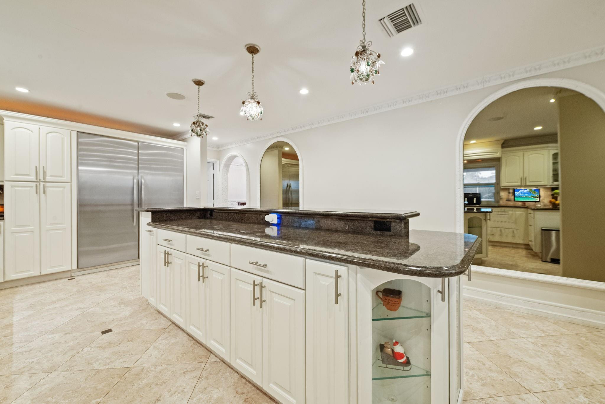 17501 Southwest 54th Street Southwest Ranches, FL 33331 - Photo 18 of 39 a kitchen with granite countertop a sink a stove and cabinets