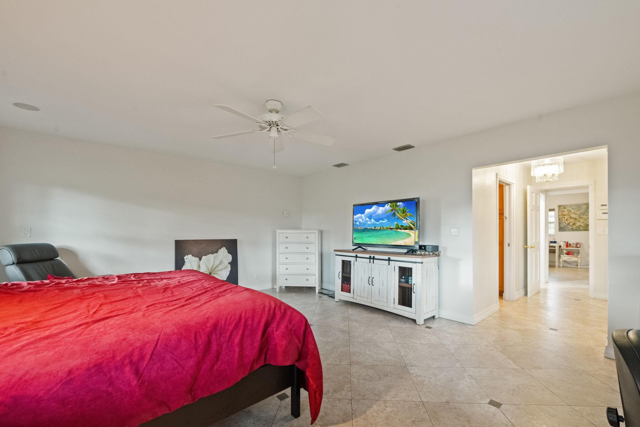 17501 Southwest 54th Street Southwest Ranches, FL 33331 - Photo 22 of 39 a spacious bedroom with a bed and a flat screen tv