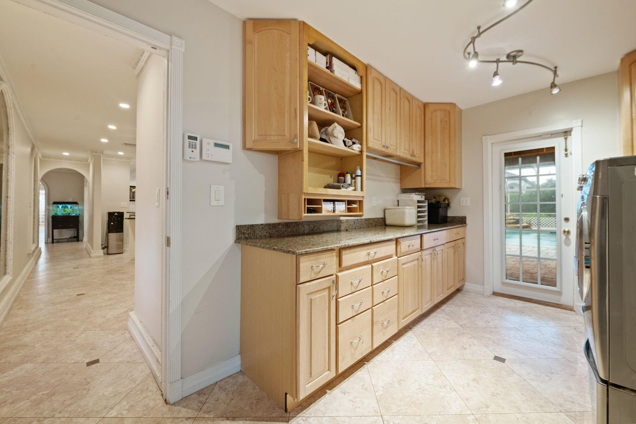 17501 Southwest 54th Street Southwest Ranches, FL 33331 - Photo 29 of 39 a kitchen with stainless steel appliances granite countertop a refrigerator a sink and white cabinets