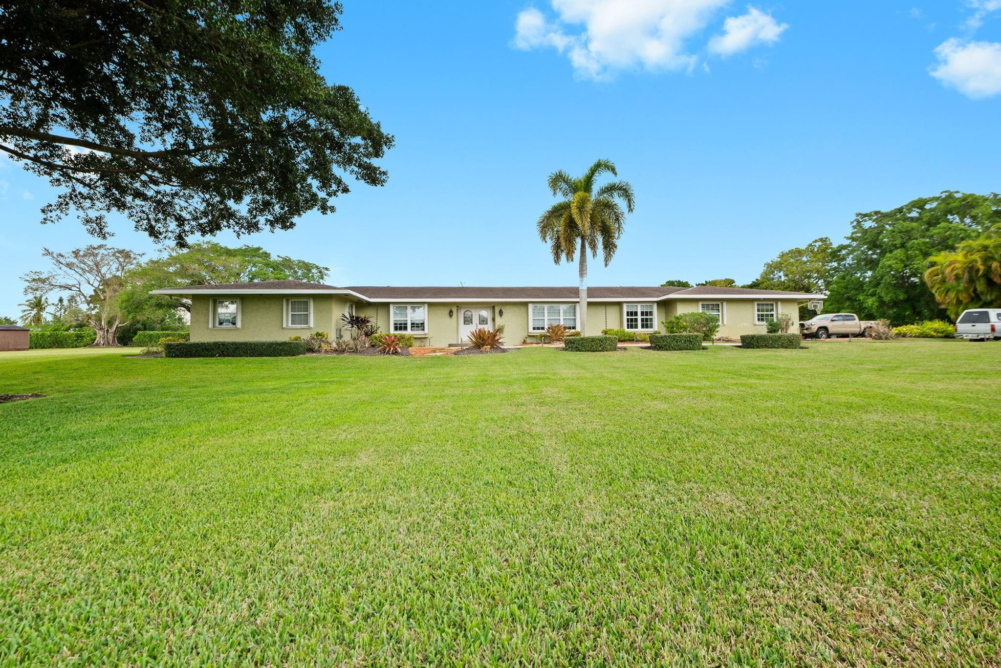 17501 Southwest 54th Street Southwest Ranches, FL 33331 - Photo 7 of 39 a view of a swimming pool with lawn chairs and plants